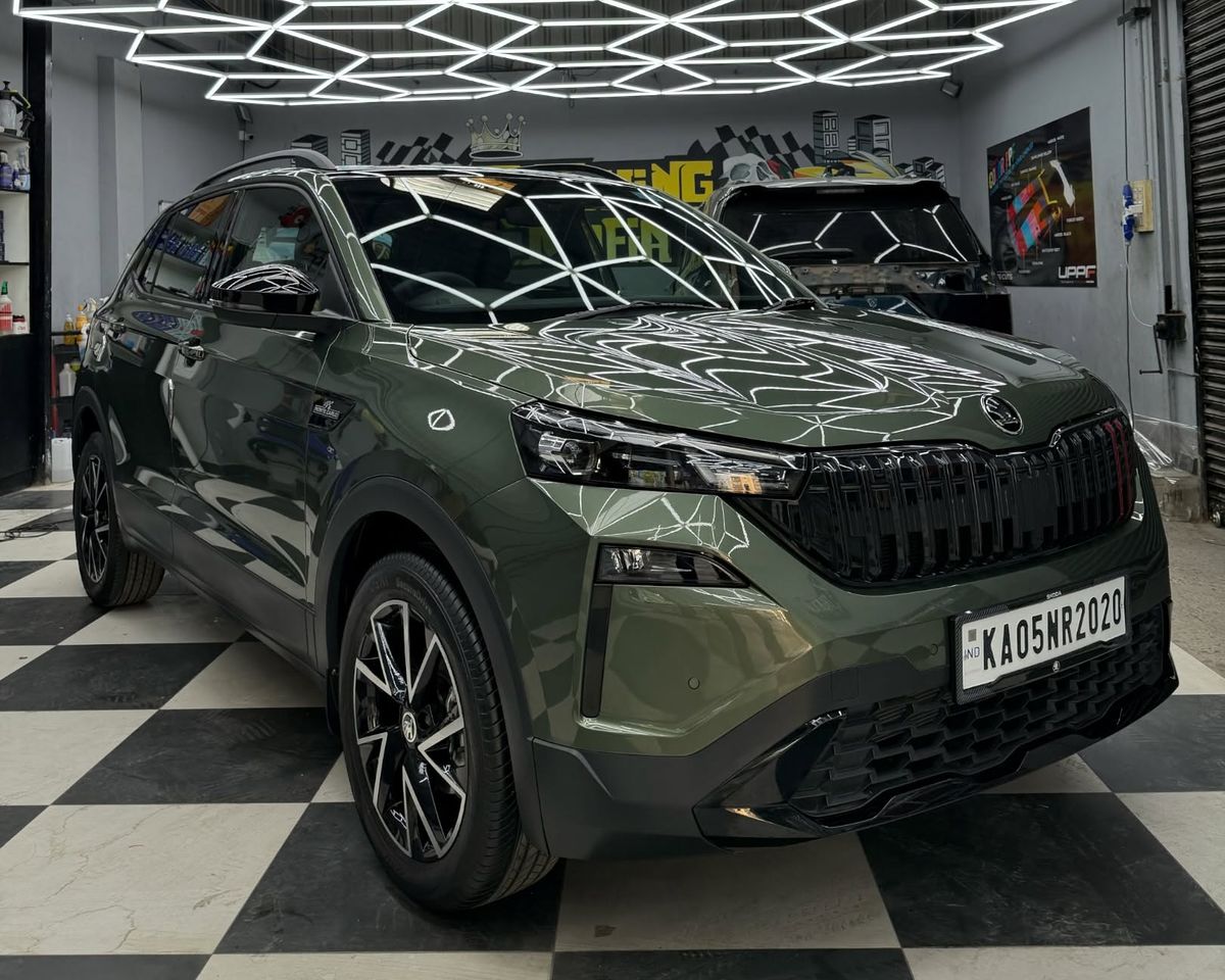 Green Skoda Kushaq with a deep gloss finish under the studio lights